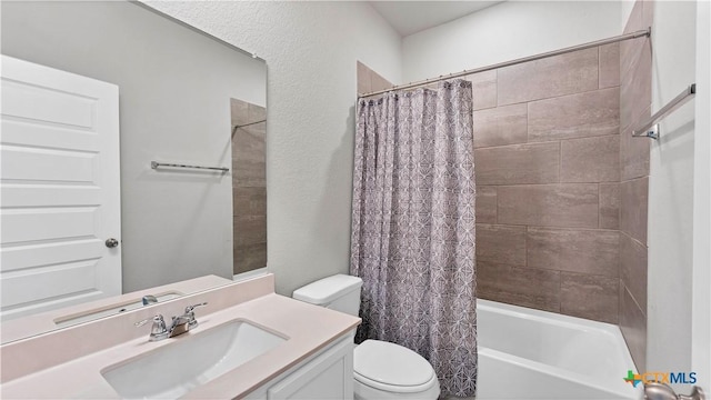 bathroom featuring shower / tub combo, vanity, and toilet