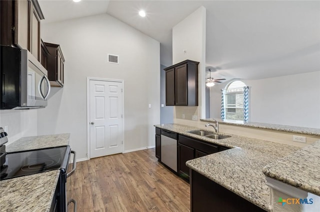1328 Blue Leaf Dr, Temple, TX 76502 - kitchen featuring dark brown cabinets, a sink, high vaulted ceiling, stainless steel appliances, and visible vents
