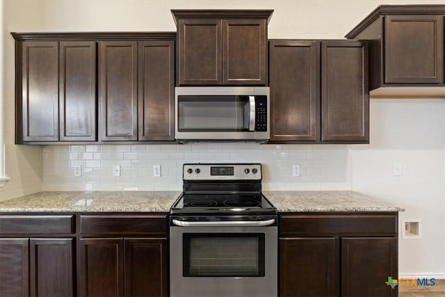 1328 Blue Leaf Dr, Temple, TX 76502 - kitchen featuring light stone counters, decorative backsplash, appliances with stainless steel finishes, and dark brown cabinets