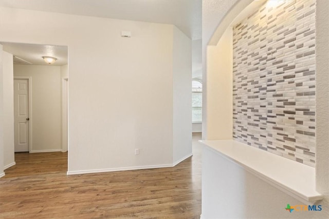 1328 Blue Leaf Dr, Temple, TX 76502 - hall with arched walkways, baseboards, and wood finished floors