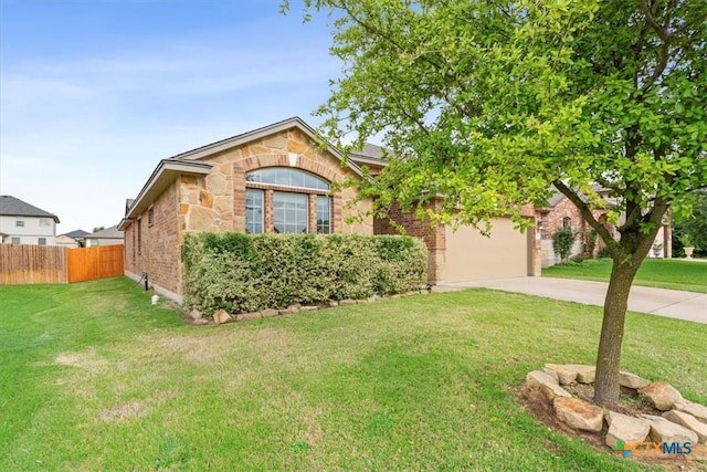 1328 Blue Leaf Dr, Temple, TX 76502 - view of front of house featuring a front yard, a garage, brick siding, fence, and concrete driveway