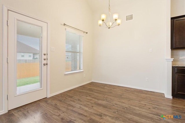 1328 Blue Leaf Dr, Temple, TX 76502 - unfurnished dining area with baseboards, a notable chandelier, visible vents, and wood finished floors