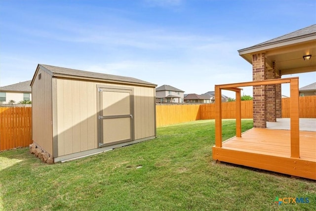 1328 Blue Leaf Dr, Temple, TX 76502 - view of yard with an outdoor structure, a wooden deck, a fenced backyard, and a shed