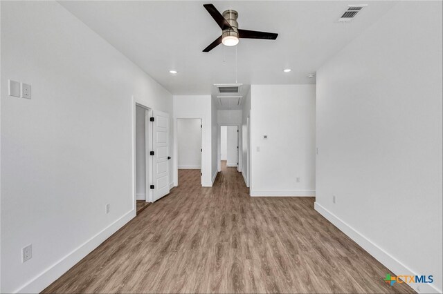 unfurnished bedroom with ceiling fan and light wood-type flooring