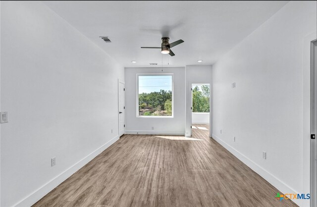 spare room with hardwood / wood-style flooring and ceiling fan