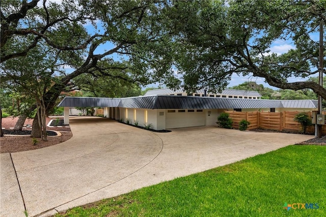 9 Mission Trce, New Braunfels, TX 78130 - view of front of property featuring driveway, a metal roof, a carport, and a garage