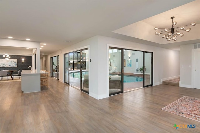 9 Mission Trce, New Braunfels, TX 78130 - kitchen with a chandelier, wood finished floors, recessed lighting, pendant lighting, and light countertops