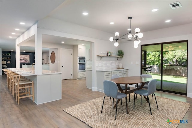 9 Mission Trce, New Braunfels, TX 78130 - dining area featuring light wood-type flooring, recessed lighting, and a chandelier