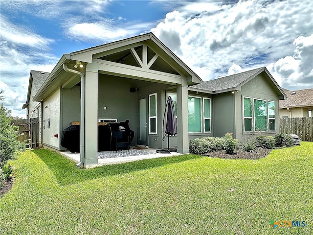 back of house featuring a yard and a patio area