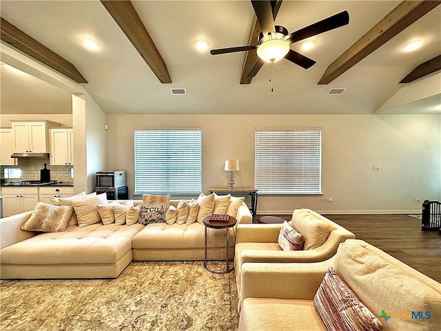 living room featuring hardwood / wood-style floors, ceiling fan, and vaulted ceiling with beams