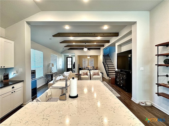 kitchen featuring dark wood-type flooring, dark stone countertops, ceiling fan, and white cabinets