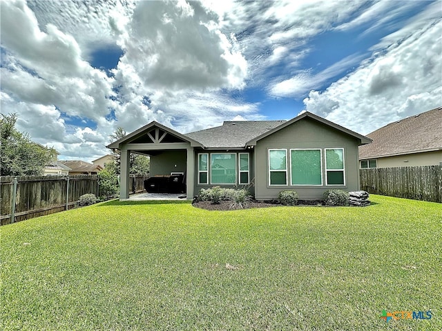 rear view of house featuring a yard and a patio area