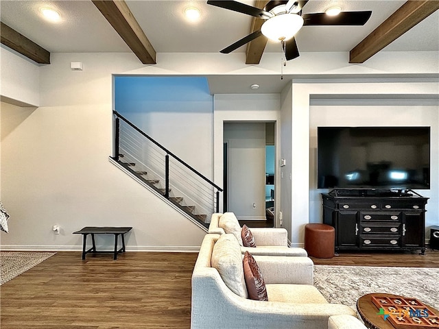 living room with beamed ceiling, ceiling fan, and dark hardwood / wood-style floors