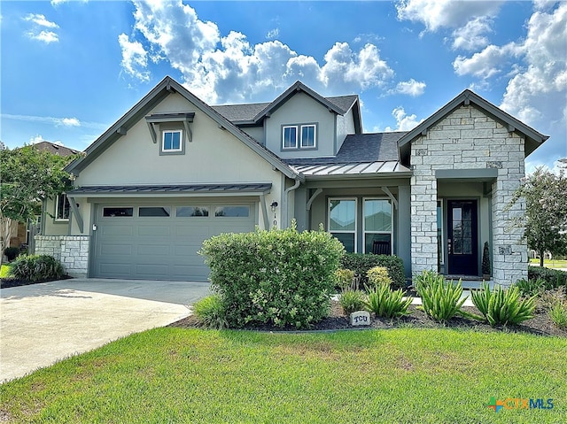 view of front of house featuring a garage and a front lawn