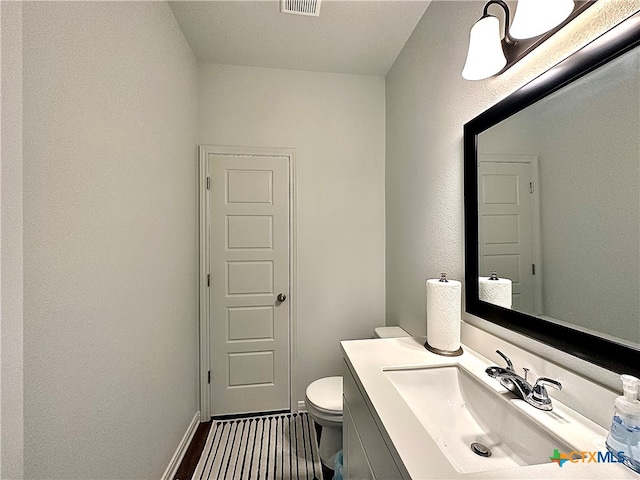 bathroom with vanity and toilet