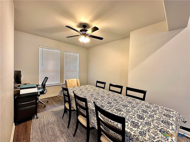 dining space with hardwood / wood-style floors and ceiling fan