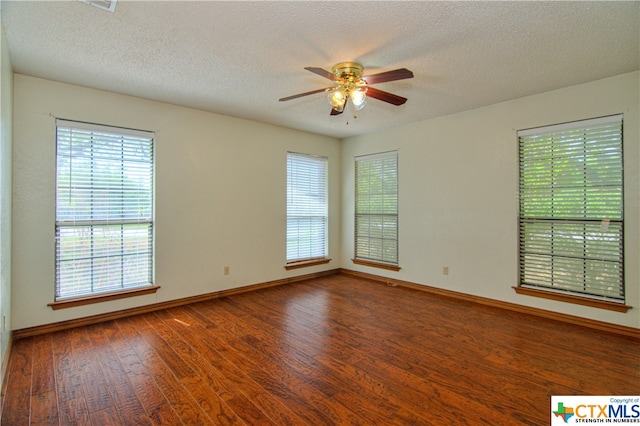 empty room with hardwood / wood-style floors, ceiling fan, and a textured ceiling