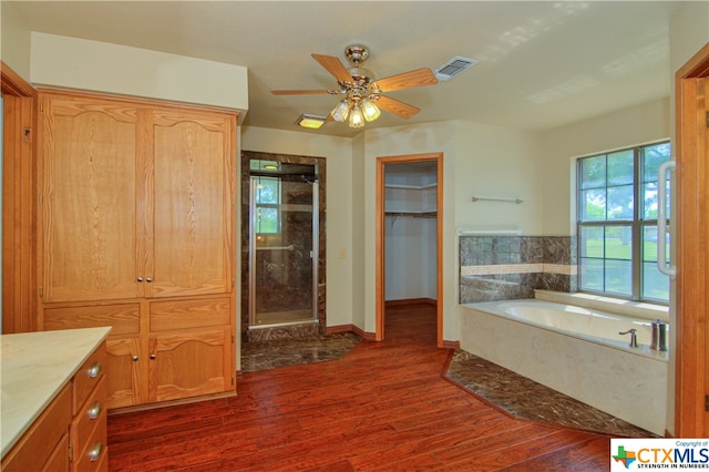 bathroom featuring hardwood / wood-style flooring, ceiling fan, vanity, and independent shower and bath