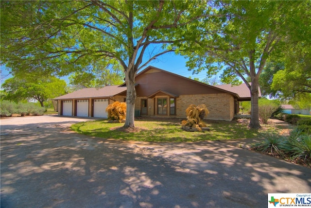 ranch-style house featuring a garage