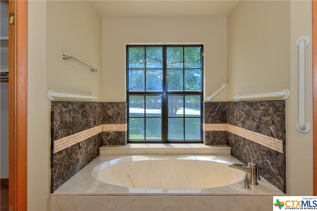 bathroom featuring tiled bath