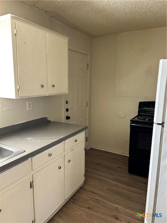 kitchen with a textured ceiling, white cabinetry, dark wood-type flooring, and black electric range