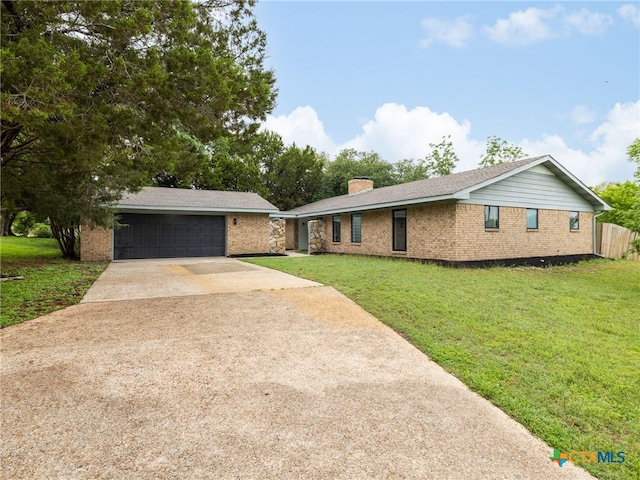 ranch-style home with driveway, brick siding, a chimney, and a front lawn