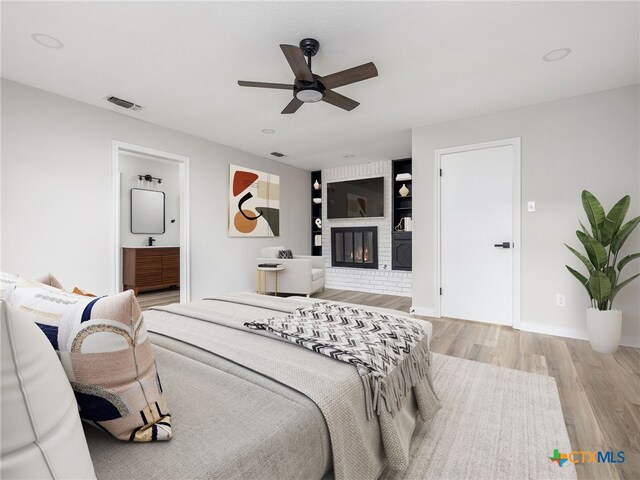 1168 Mildred Lee Ln, Harker Heights, TX 76548 - bedroom with wood finished floors, a fireplace, a ceiling fan, ensuite bath, and baseboards