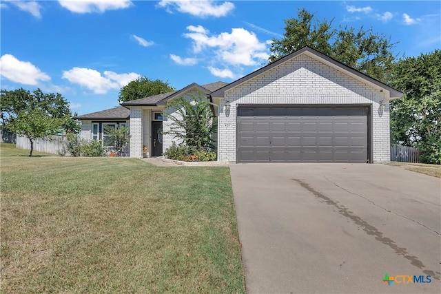 view of front of property with a front lawn and a garage