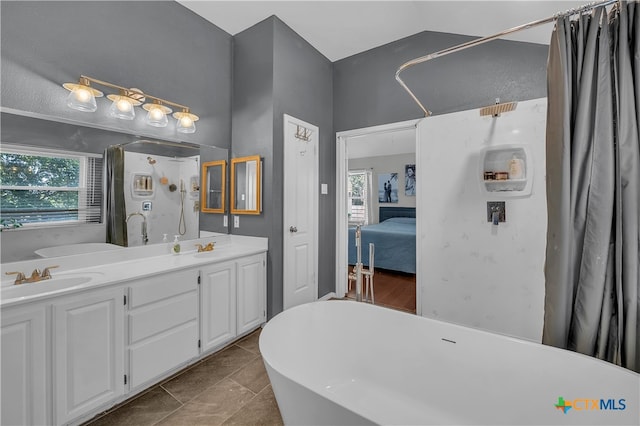 bathroom featuring a tub, tile patterned flooring, and vanity