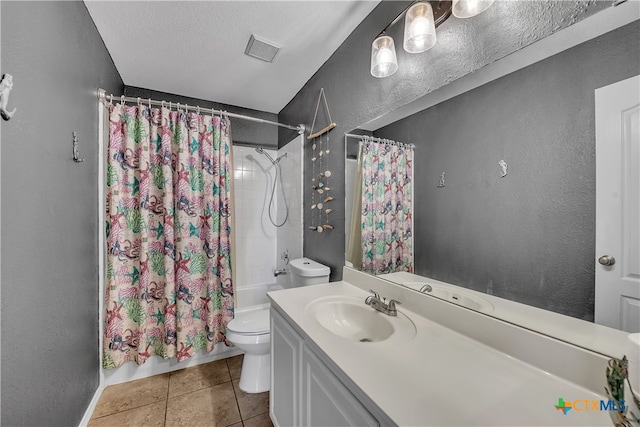 full bathroom featuring vanity, tile patterned flooring, toilet, shower / bath combo with shower curtain, and a textured ceiling