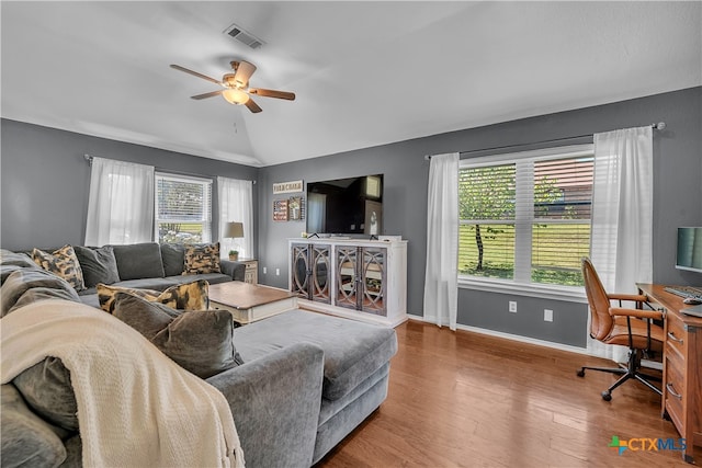 living room featuring a healthy amount of sunlight, ceiling fan, lofted ceiling, and hardwood / wood-style floors