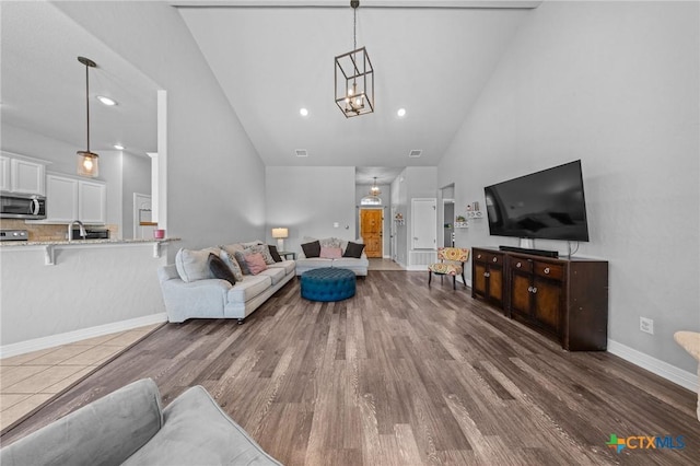 10103 Taylor Renee Dr, Killeen, TX 76542 - living room with high vaulted ceiling, a chandelier, wood finished floors, and recessed lighting