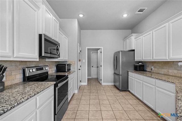 10103 Taylor Renee Dr, Killeen, TX 76542 - kitchen featuring appliances with stainless steel finishes, white cabinets, backsplash, light tile patterned floors, and recessed lighting