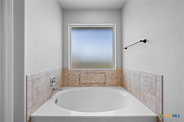 10103 Taylor Renee Dr, Killeen, TX 76542 - bathroom with a bath and a textured wall