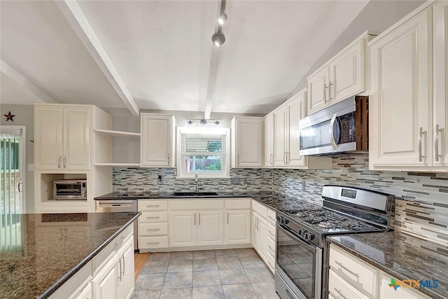 1802 Chestnut St, Floresville, TX 78114 - kitchen with appliances with stainless steel finishes, open shelves, healthy amount of natural light, backsplash, and beam ceiling