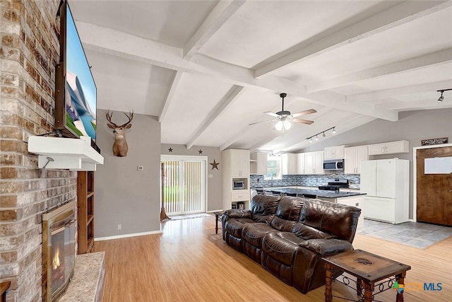 1802 Chestnut St, Floresville, TX 78114 - living room featuring light wood finished floors, a fireplace, and ceiling fan