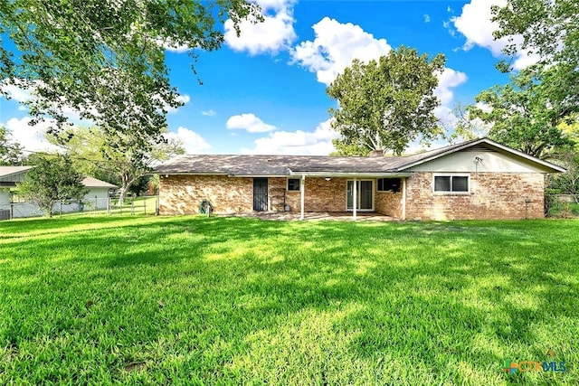 1802 Chestnut St, Floresville, TX 78114 - rear view of property featuring brick siding and a patio