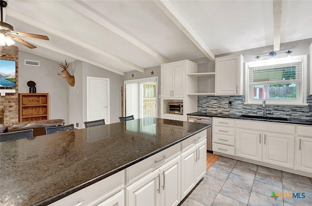 1802 Chestnut St, Floresville, TX 78114 - kitchen featuring open shelves, decorative backsplash, stainless steel dishwasher, a ceiling fan, and white cabinetry