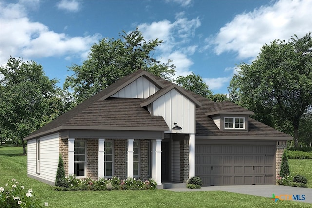 view of front of property featuring a front yard and a garage