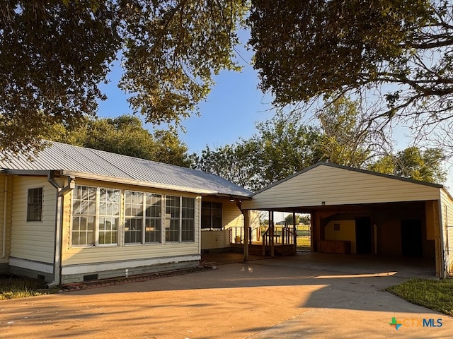 548 County Road 303, Shiner, TX 77984 - rear view of property featuring crawl space, concrete driveway, a metal roof, and a carport