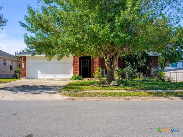 view of property hidden behind natural elements featuring a garage