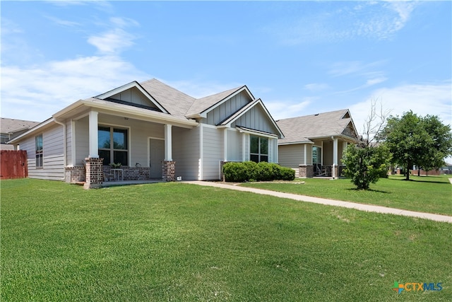 7628 Copper Creek Trl, Temple, TX 76502 - craftsman-style house with a porch, board and batten siding, a front yard, and brick siding