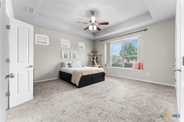 7628 Copper Creek Trl, Temple, TX 76502 - carpeted bedroom featuring a raised ceiling, baseboards, and ceiling fan