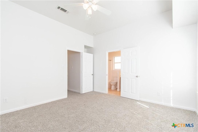 unfurnished bedroom with ensuite bath, carpet, visible vents, and baseboards