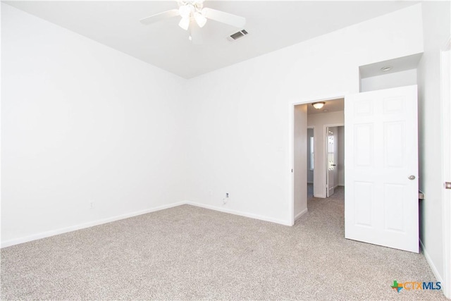 unfurnished room with baseboards, visible vents, a ceiling fan, and light colored carpet