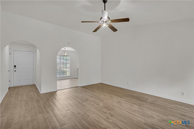 2002 Buckskin Trl, Temple, TX 76502 - empty room with arched walkways, wood finished floors, a ceiling fan, and baseboards