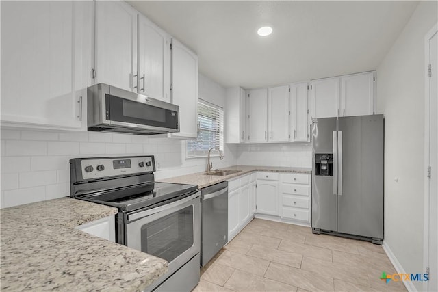 2002 Buckskin Trl, Temple, TX 76502 - kitchen featuring stainless steel appliances, a sink, white cabinets, and light tile patterned floors