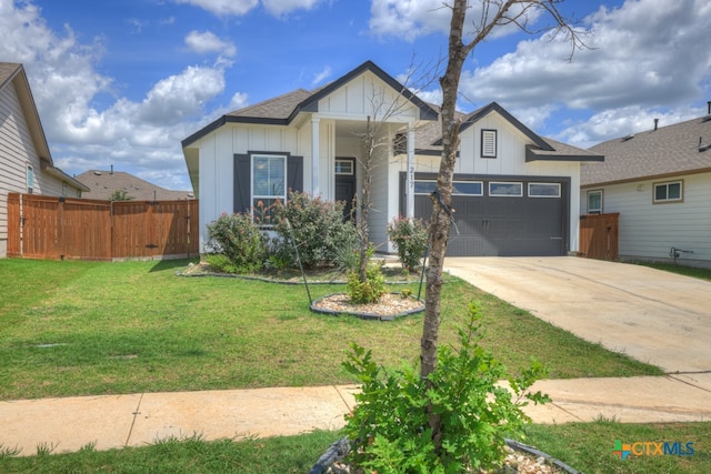 view of front of home featuring a garage and a front yard