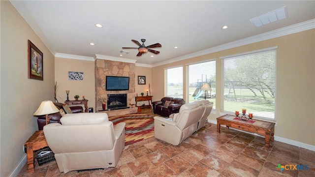 living room with ceiling fan, a stone fireplace, and crown molding