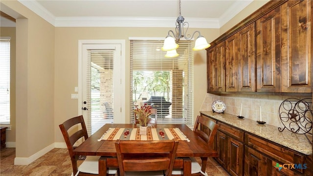 dining room featuring tile patterned floors, crown molding, and an inviting chandelier